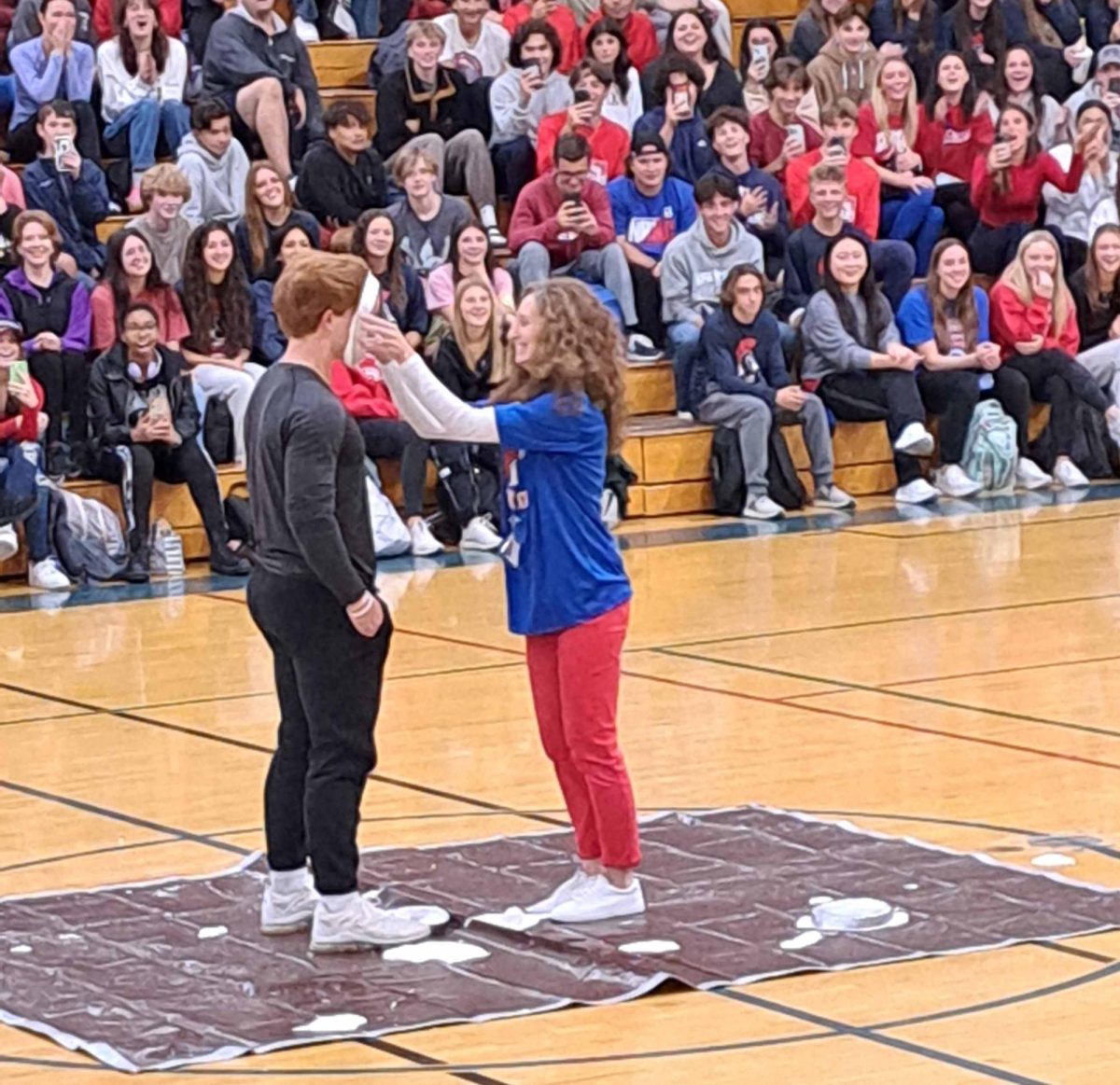 Always a winner:  Mrs. Roth pies Cole Raux at the Pep Rally