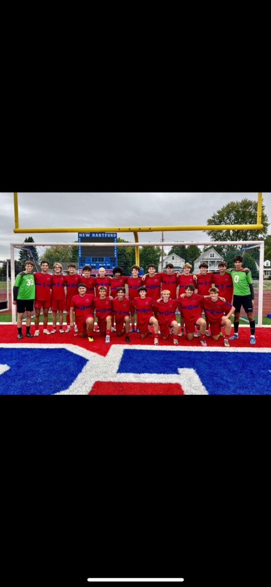 The 2024 New Hartford Varsity Boys Soccer Team in a team picture above. 