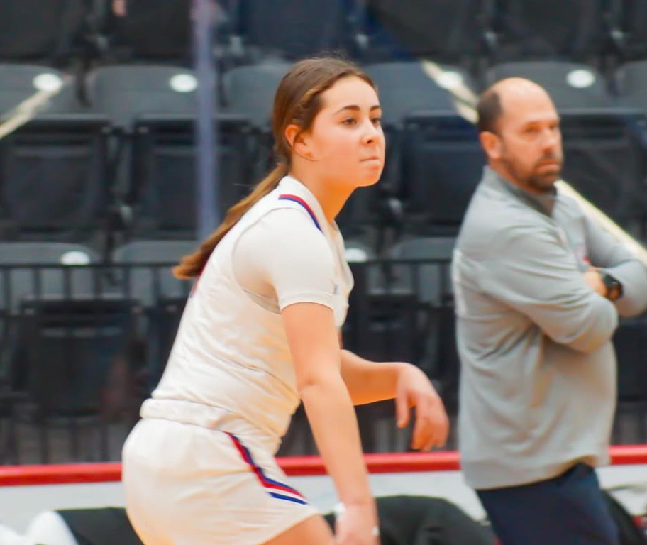 Addie Way assists the ball to a player on the Girls Varsity basketball team.