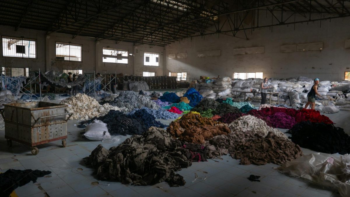 Tons of fabric being sorted through in Cambodia. Image used with permission from Unsplash.