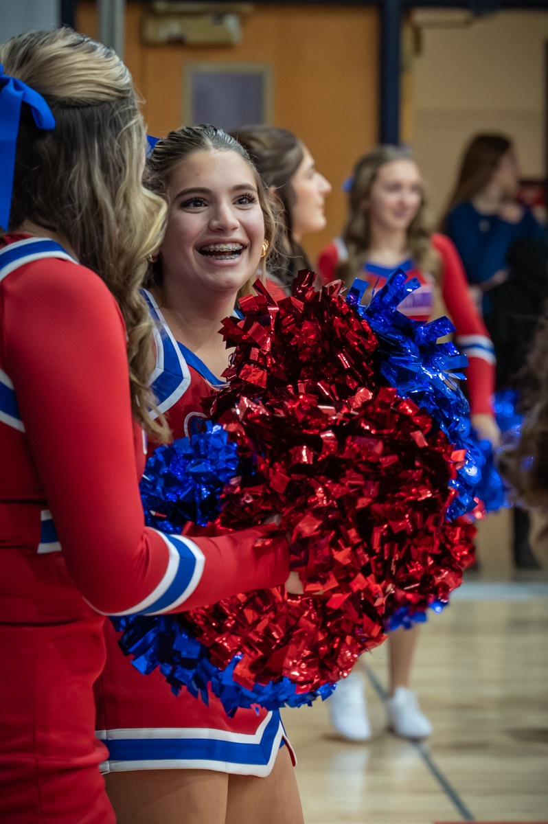 Grace smiles as she cheers on the sidelines of the boy's Varsity basketball game.