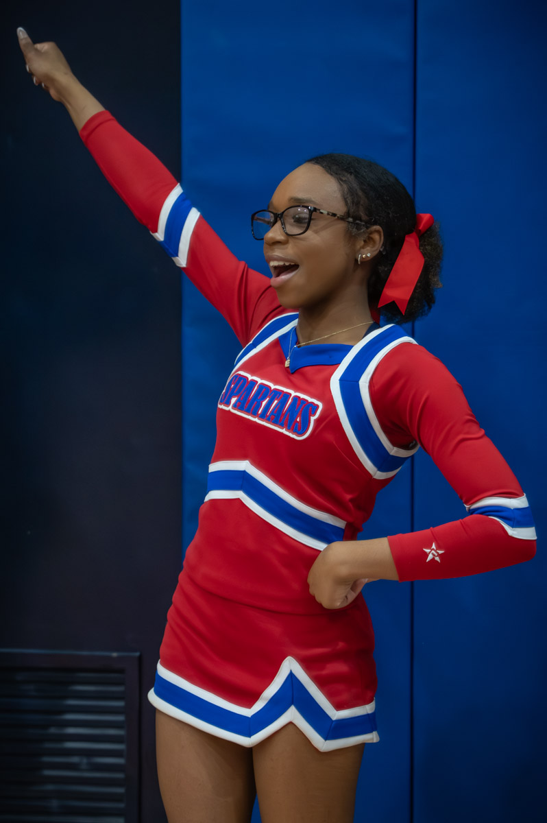 Senior Elizabeth Burnett cheering at a girls varsity game. 